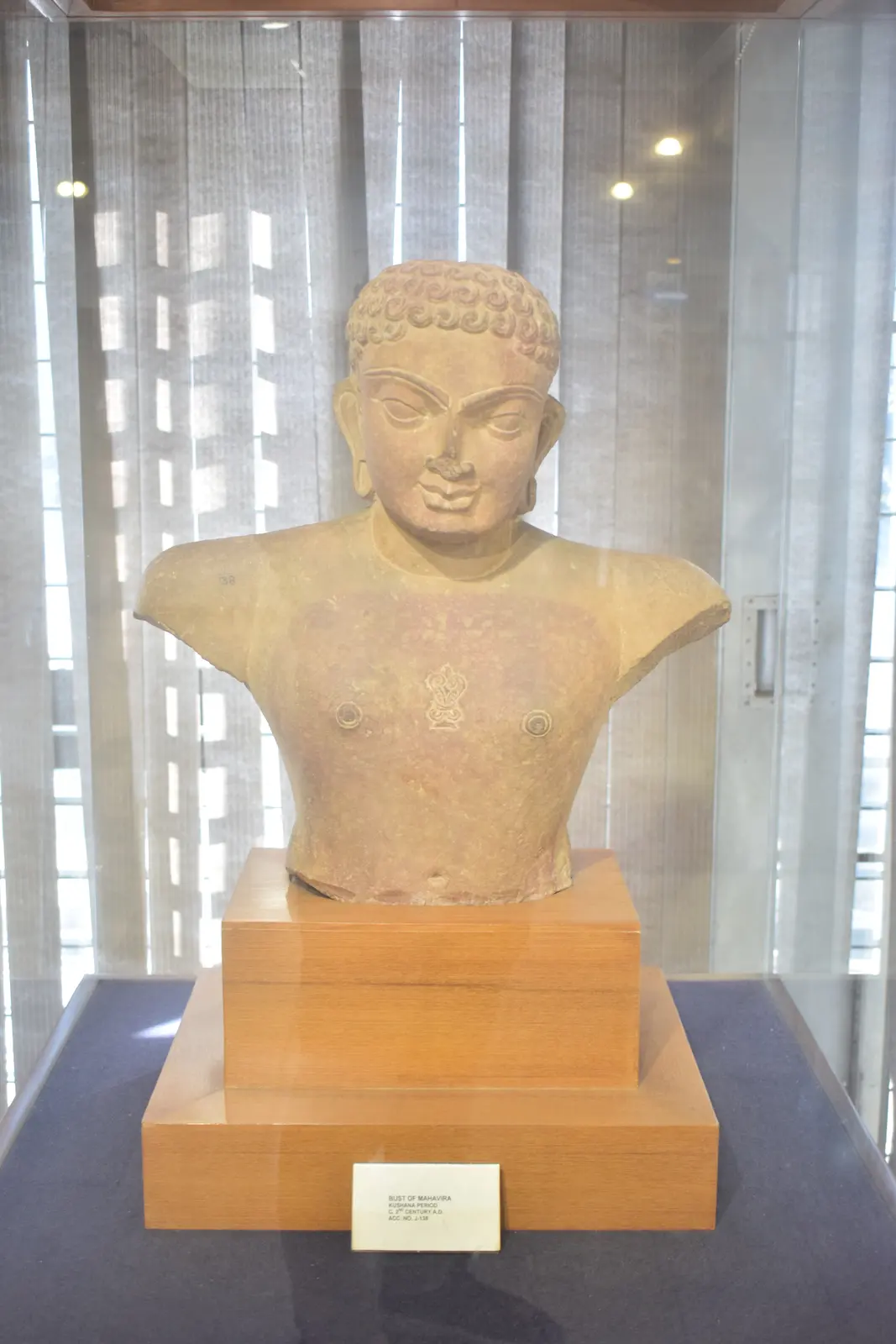 Stone sculpture representing Mahavira in a museum